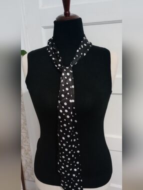 Sleek Black Sleeveless Turtleneck Tank Top And polka Dot Skinny Scarf.